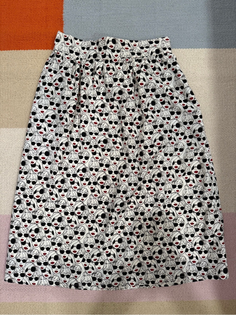 A-Line White Midi Skirt with Black Graphic Face Print and Red Accent